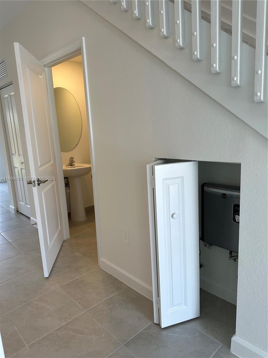 11767 Southwest 246th Terrace Homestead, FL 33032 - Photo 5 of 29 a view of a bathroom from a corridor