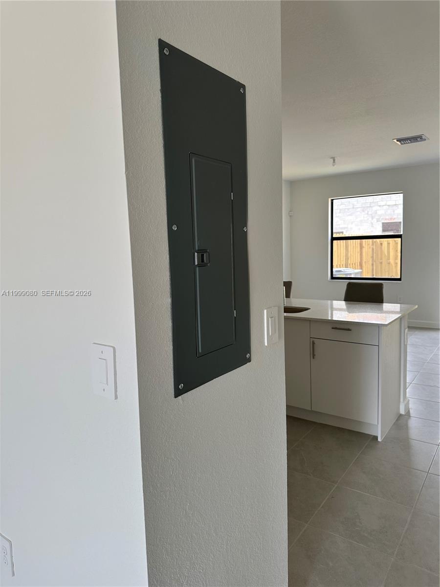 11767 Southwest 246th Terrace Homestead, FL 33032 - Photo 7 of 29 a kitchen with white cabinets and white appliances