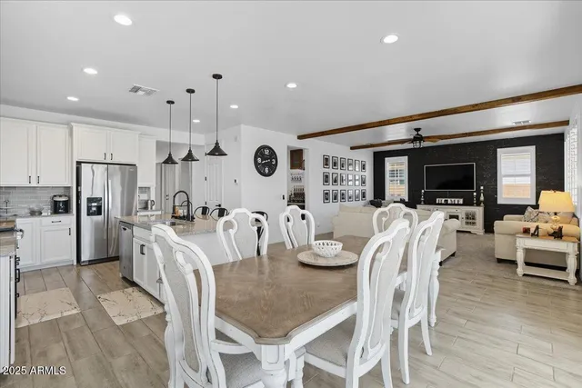 a large kitchen with a table and chairs