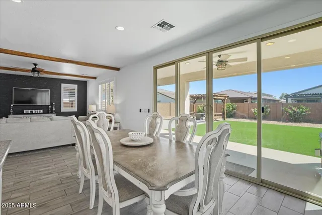 a dining room with furniture water view and a floor to ceiling window