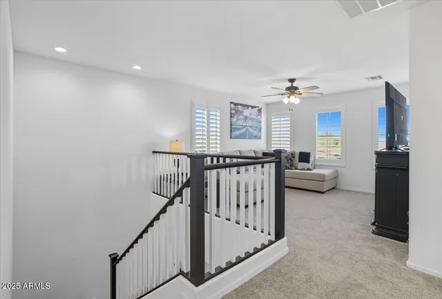 a view of a livingroom with furniture and stairs