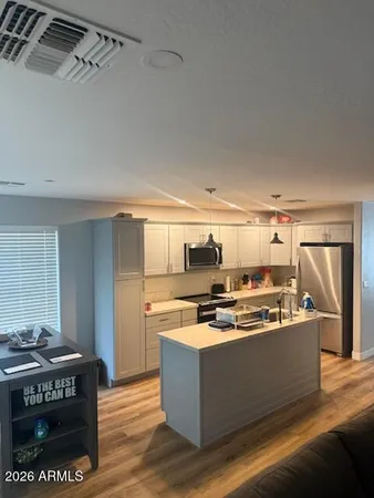 a kitchen with stainless steel appliances granite countertop a stove and a refrigerator