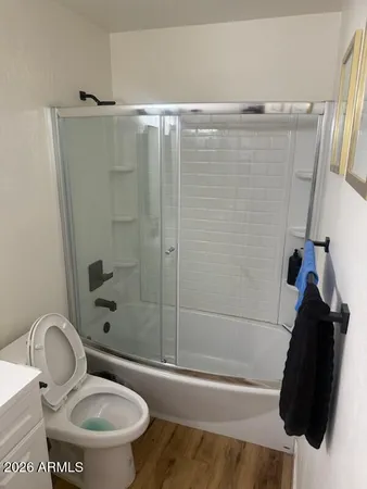 a bathroom with a toilet and a shower
