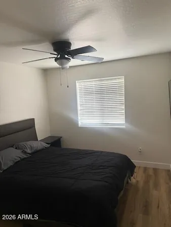 a bed sitting in a bedroom next to a window