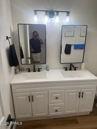 a bathroom with a sink and mirror