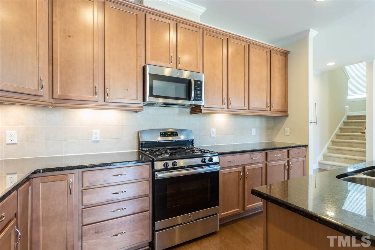 4244 Rockdell Hall Street Raleigh, NC 27616 - Photo 12 of 29 a kitchen with stainless steel appliances granite countertop a stove a sink and a microwave