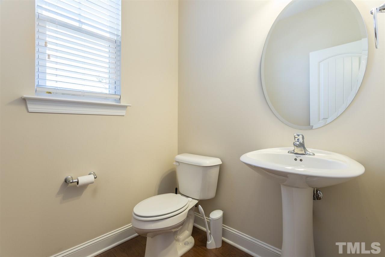4244 Rockdell Hall Street Raleigh, NC 27616 - Photo 17 of 29 a bathroom with a toilet a sink and a mirror