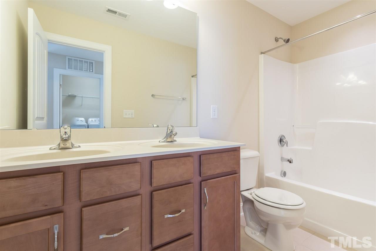 4244 Rockdell Hall Street Raleigh, NC 27616 - Photo 22 of 29 a bathroom with a sink a toilet and shower