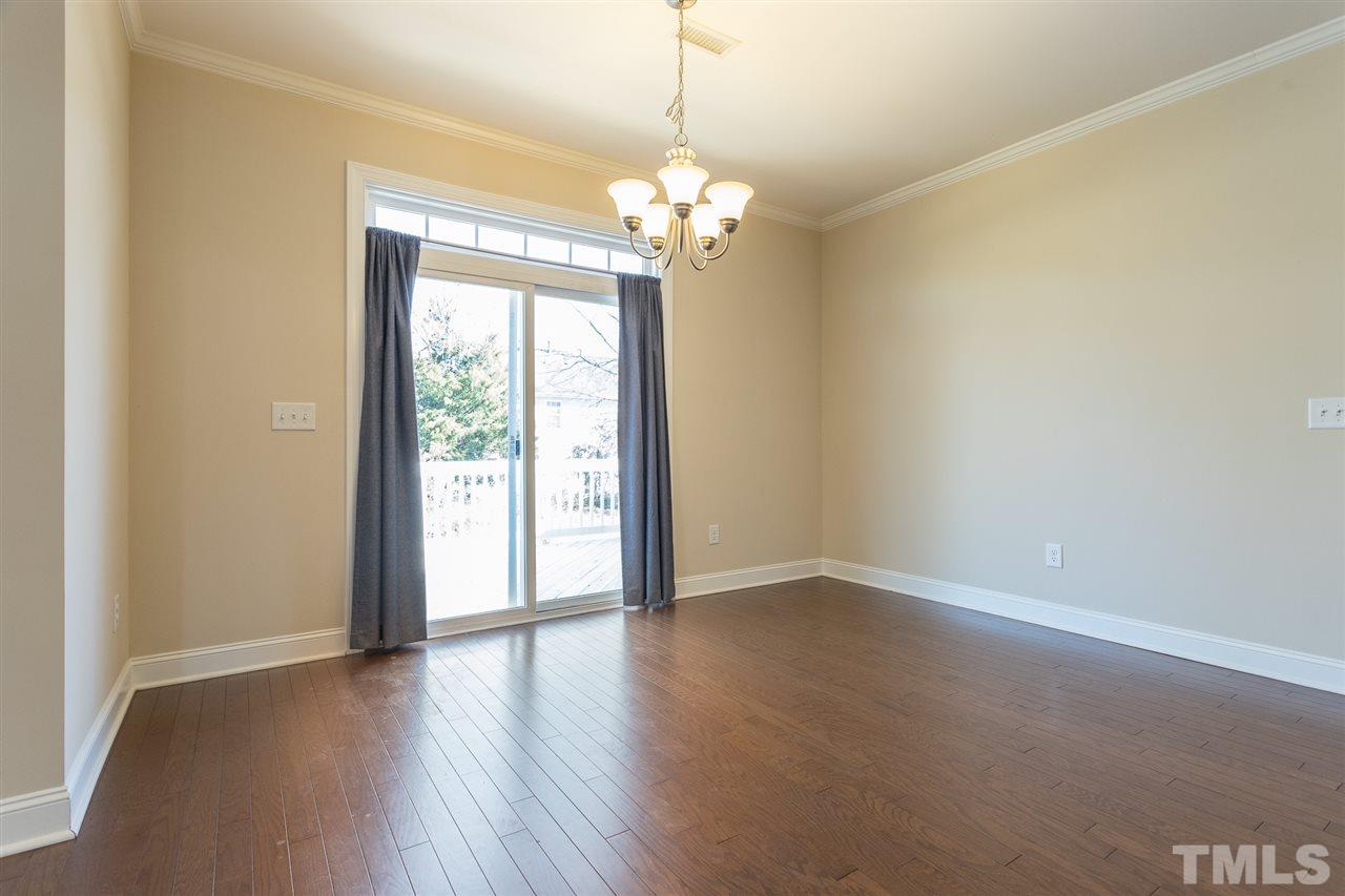 4244 Rockdell Hall Street Raleigh, NC 27616 - Photo 10 of 29 a view of an empty room with a window and wooden floor