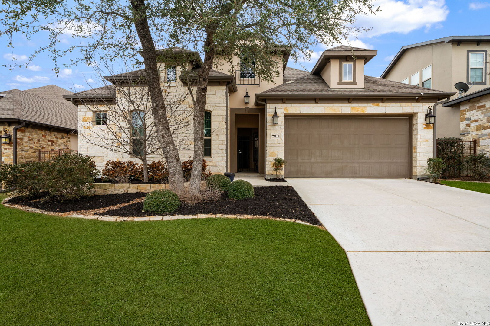 a front view of a house with a yard and garage
