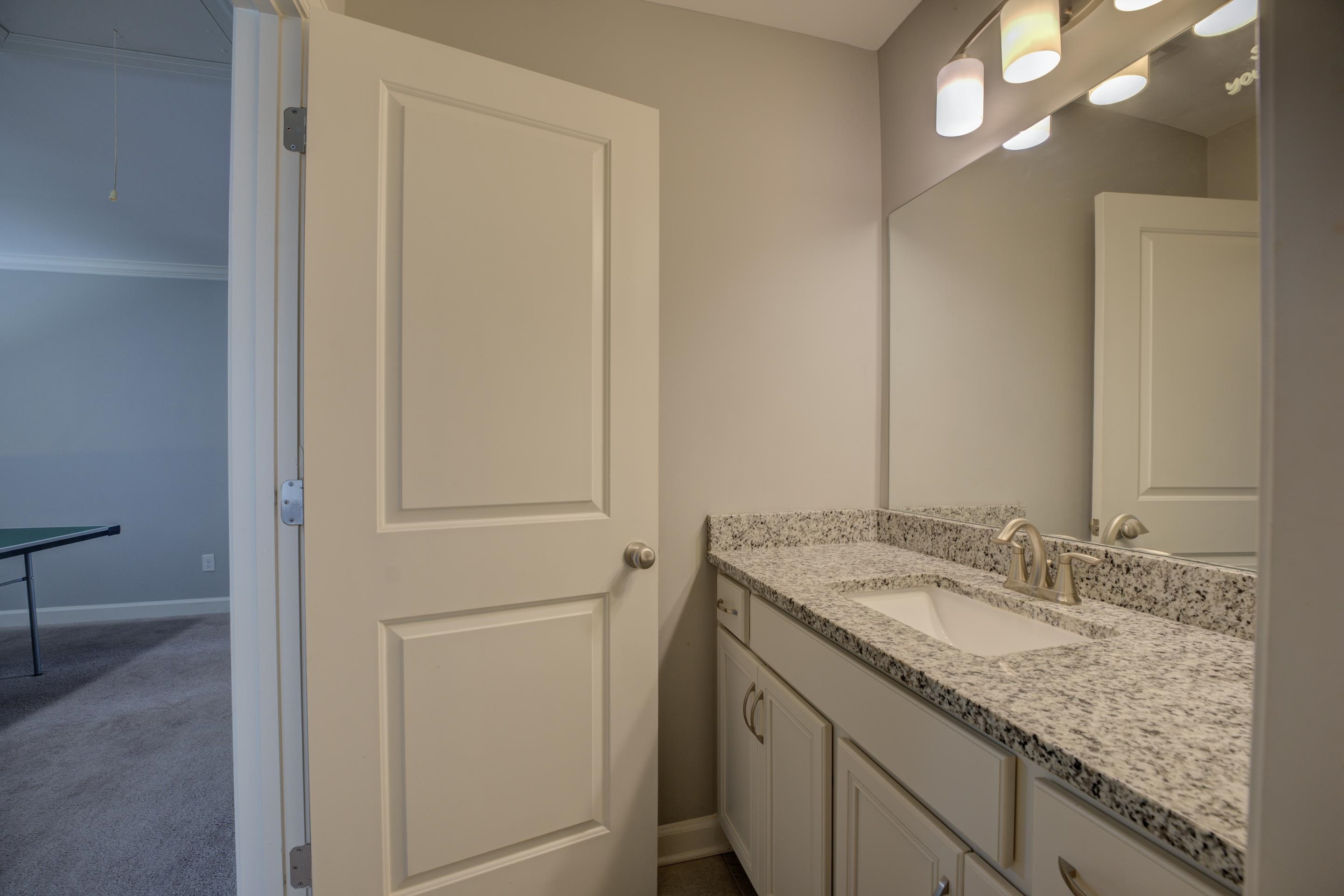 6374 Rutherford Circle Arlington, TN 38002 - Photo 12 of 40 a bathroom with a granite countertop sink and a mirror