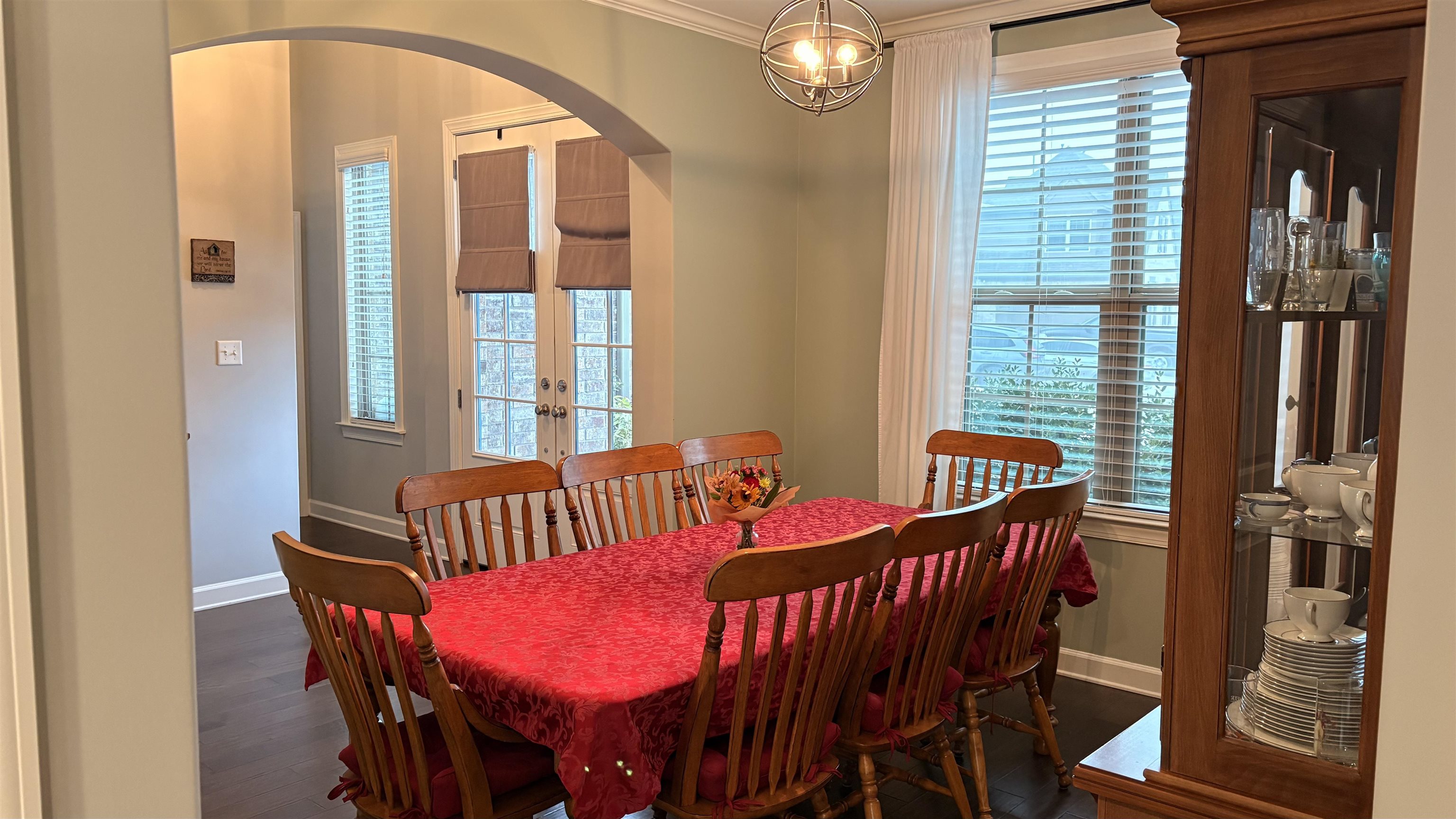 6374 Rutherford Circle Arlington, TN 38002 - Photo 32 of 40 Dining space with arched walkways, ornamental molding, dark wood-style flooring, and french doors