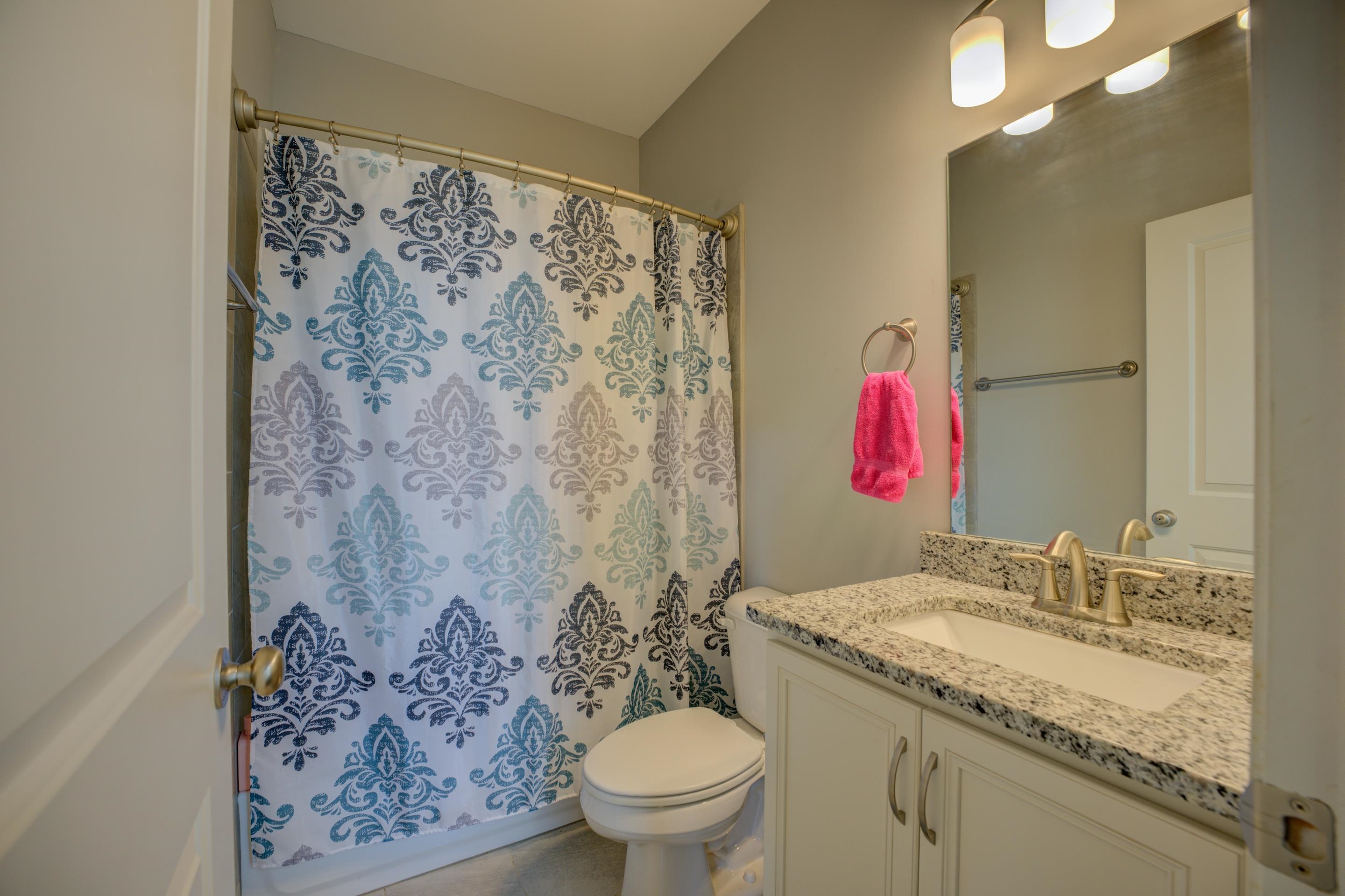6374 Rutherford Circle Arlington, TN 38002 - Photo 36 of 40 a bathroom with a granite countertop sink a toilet and a shower