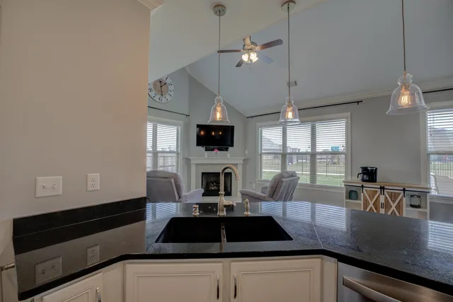 a bathroom with a granite countertop sink a toilet and a shower