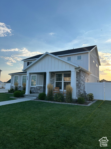 View of front of house featuring a yard and covered porch