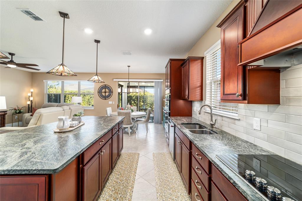 6382 Southwest 97th Terrace Road Ocala, FL 34481 - Photo 13 of 56 a kitchen with sink stove and cabinets