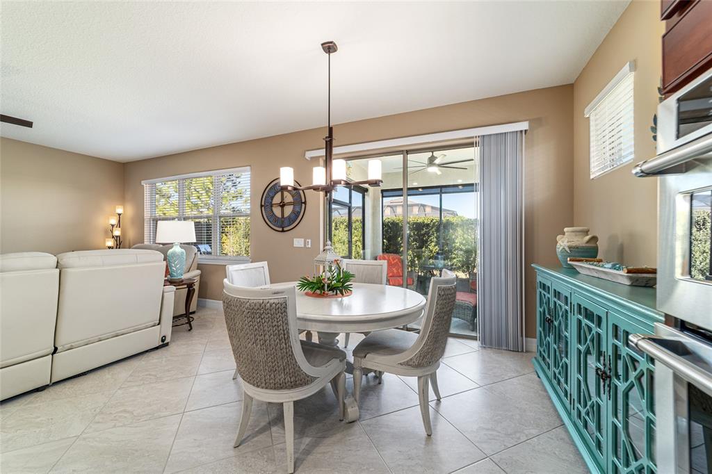 6382 Southwest 97th Terrace Road Ocala, FL 34481 - Photo 17 of 56 a dining room with furniture a chandelier and fireplace