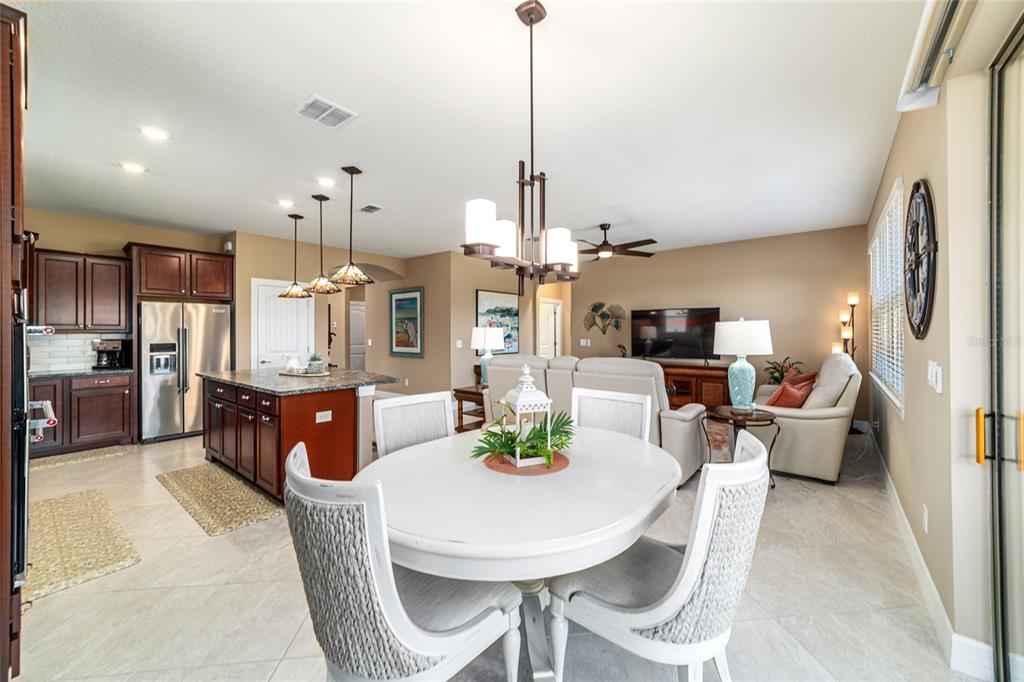 6382 Southwest 97th Terrace Road Ocala, FL 34481 - Photo 18 of 56 a dining room with furniture a window and kitchen view