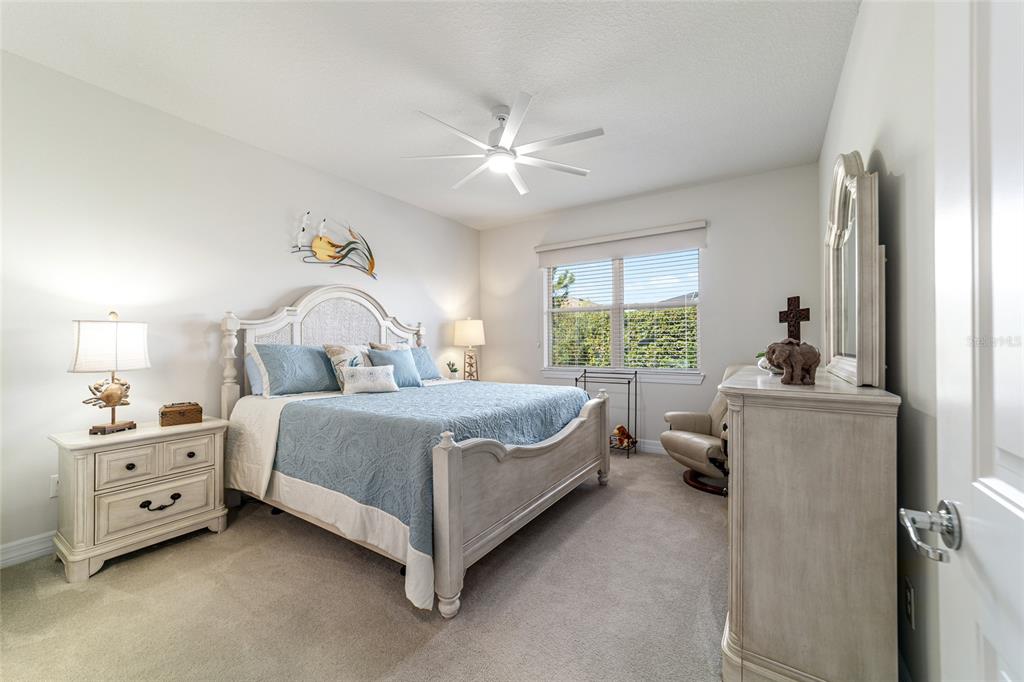 6382 Southwest 97th Terrace Road Ocala, FL 34481 - Photo 20 of 56 a bedroom with a bed and a chandelier