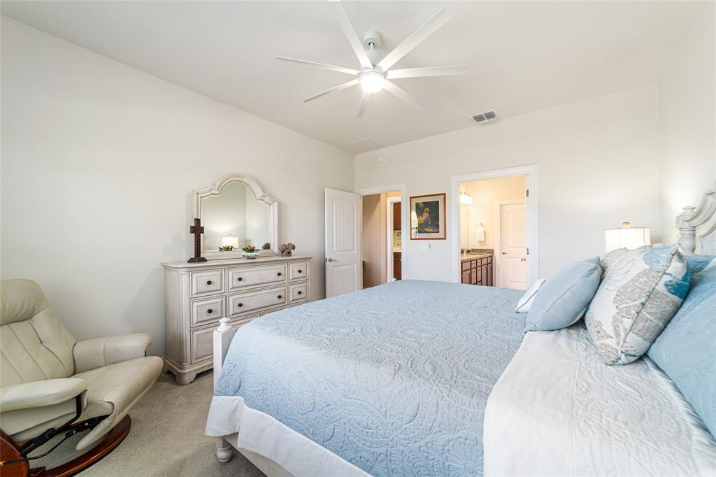 6382 Southwest 97th Terrace Road Ocala, FL 34481 - Photo 21 of 56 a spacious bedroom with a bed and furniture