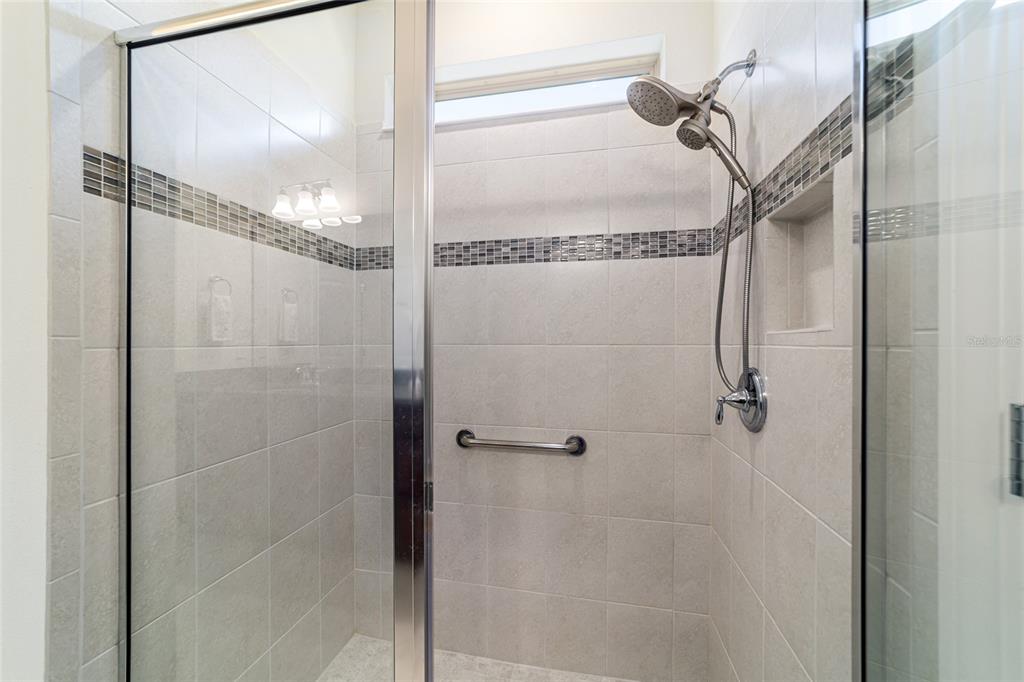 6382 Southwest 97th Terrace Road Ocala, FL 34481 - Photo 25 of 56 a bathroom with a glass shower door