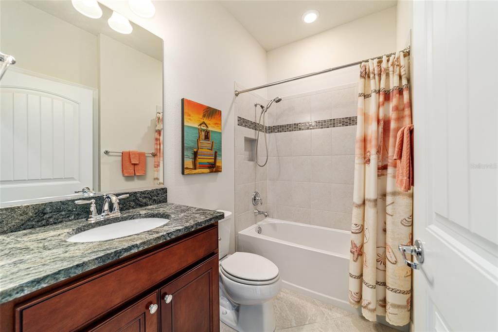 6382 Southwest 97th Terrace Road Ocala, FL 34481 - Photo 27 of 56 a bathroom with a granite countertop sink toilet and shower