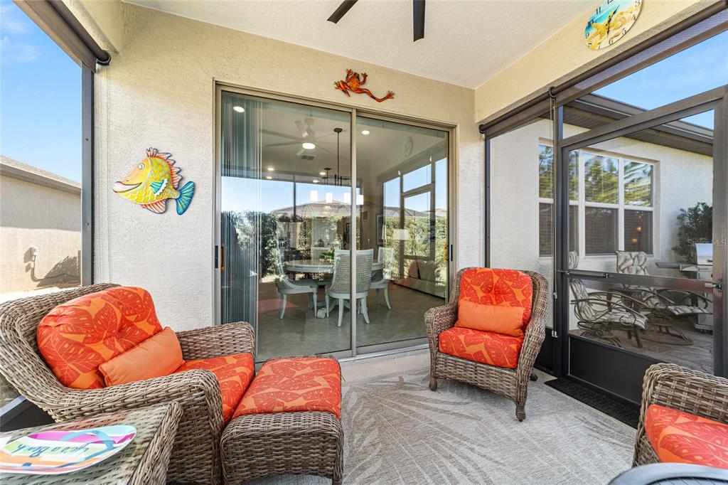 6382 Southwest 97th Terrace Road Ocala, FL 34481 - Photo 36 of 56 a outdoor living space with furniture and a floor to ceiling window
