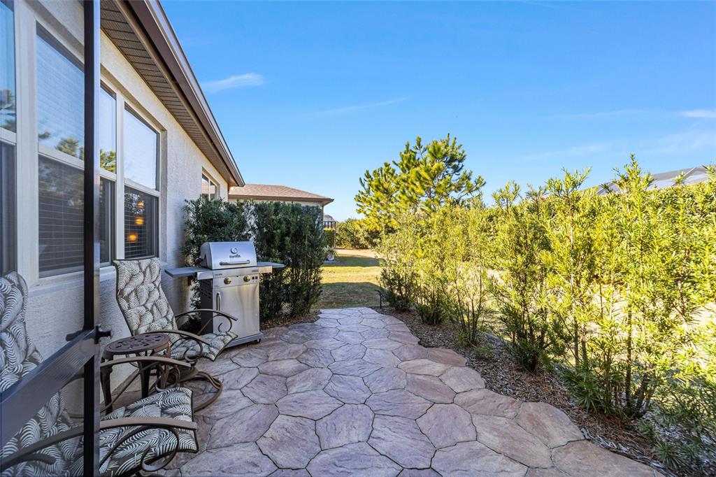 6382 Southwest 97th Terrace Road Ocala, FL 34481 - Photo 37 of 56 a view of a patio with table and chairs and potted plants