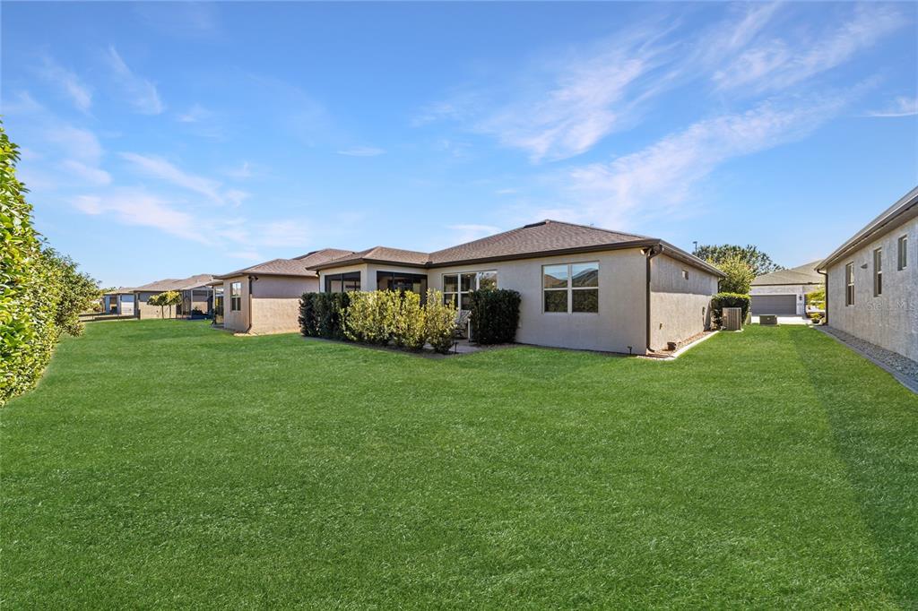 6382 Southwest 97th Terrace Road Ocala, FL 34481 - Photo 39 of 56 a view of a house with a big yard and large trees