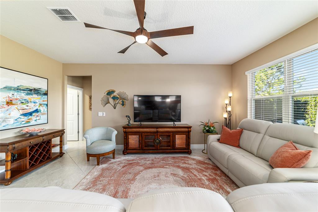 6382 Southwest 97th Terrace Road Ocala, FL 34481 - Photo 6 of 56 a living room with furniture and a flat screen tv