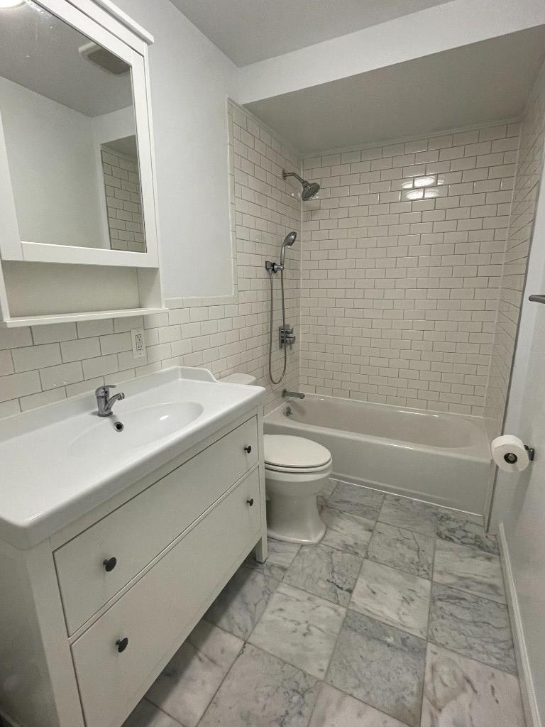 682 East 42nd Street, Unit 1 Brooklyn, NY 11203 - Photo 7 of 11 a bathroom with a sink toilet and shower