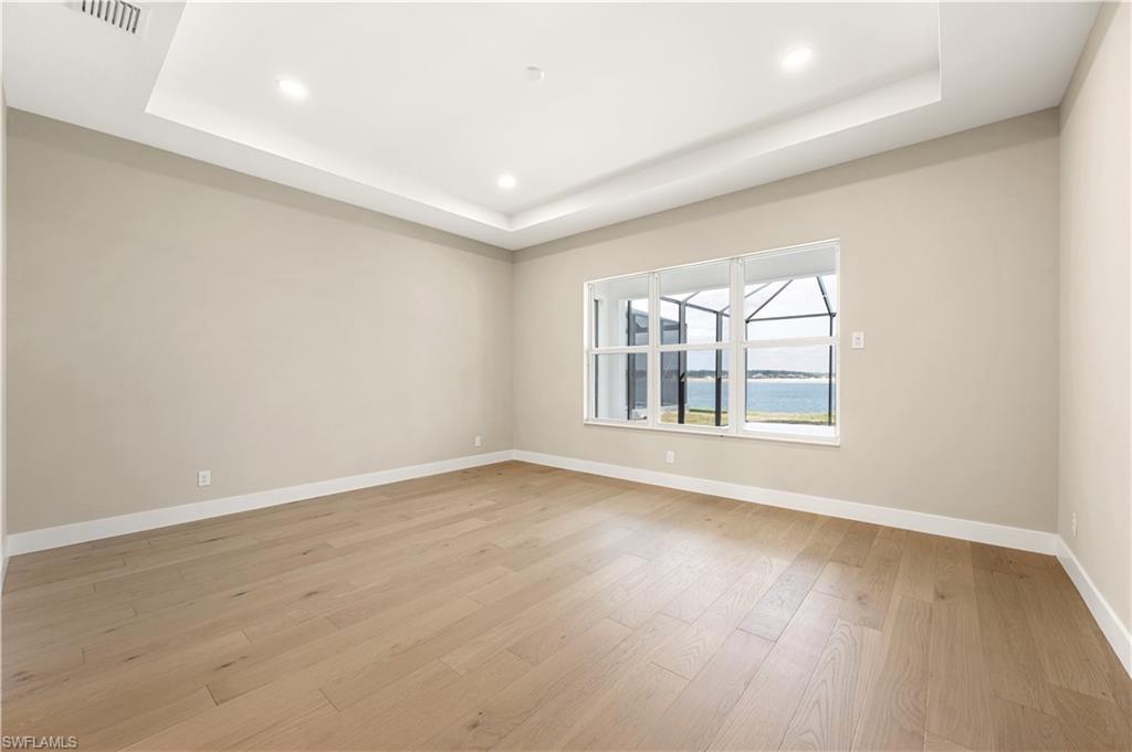 9127 Wisteria Way Naples, FL 34114 - Photo 17 of 50 wooden floor in an empty room with a window
