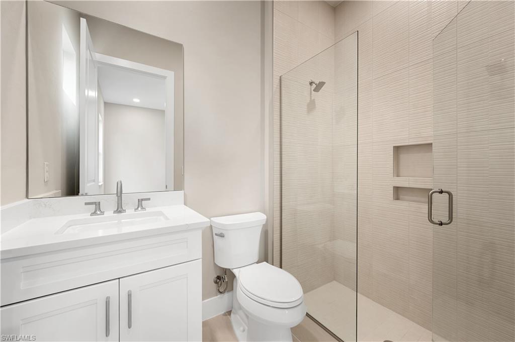 9127 Wisteria Way Naples, FL 34114 - Photo 24 of 50 a bathroom with a sink a toilet and shower