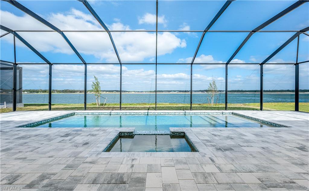 9127 Wisteria Way Naples, FL 34114 - Photo 3 of 50 a view of a swimming pool with a yard