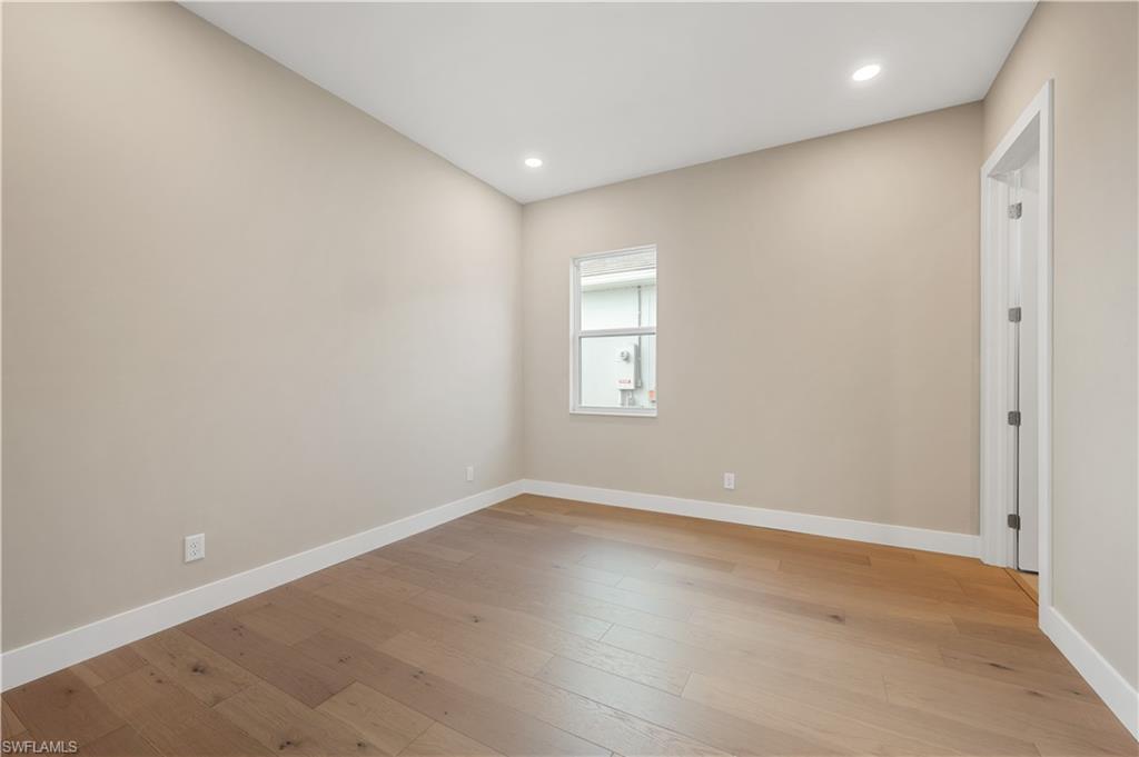 9127 Wisteria Way Naples, FL 34114 - Photo 31 of 50 an empty room with wooden floor and windows