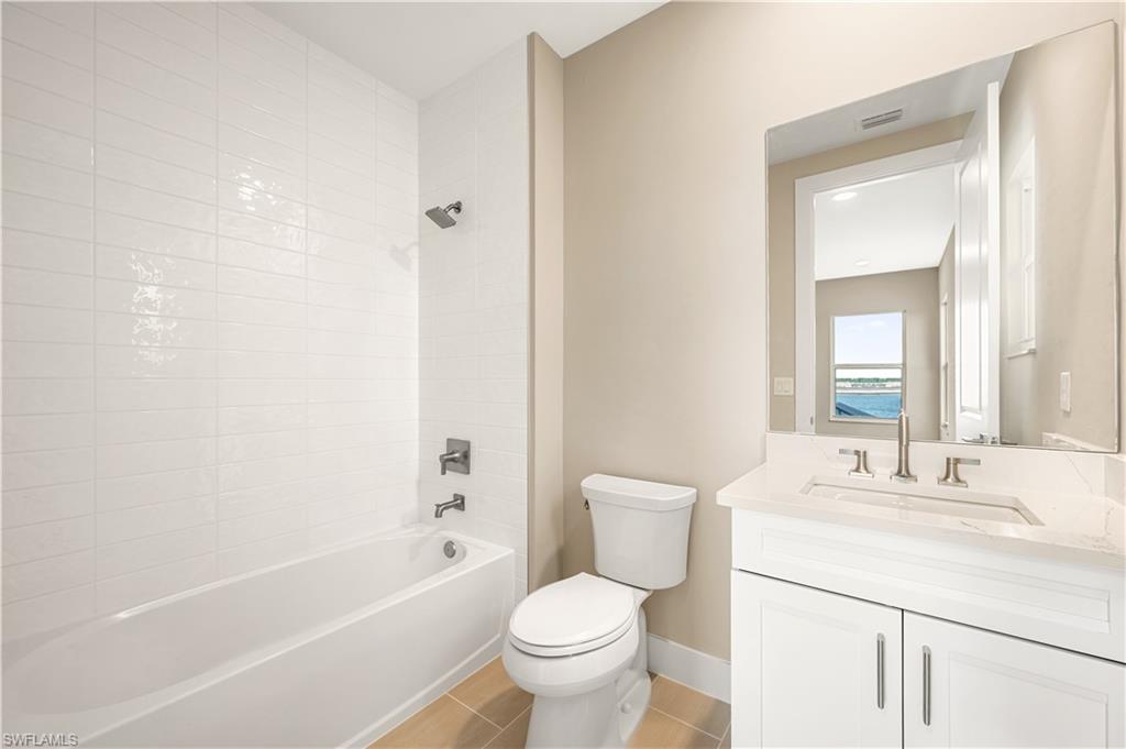 9127 Wisteria Way Naples, FL 34114 - Photo 34 of 50 a bathroom with a sink toilet vanity and shower