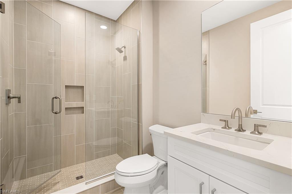 9127 Wisteria Way Naples, FL 34114 - Photo 35 of 50 a bathroom with a sink toilet and shower