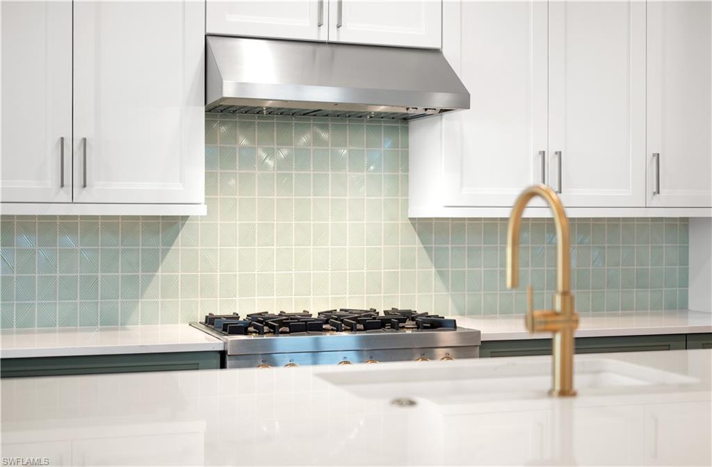 9127 Wisteria Way Naples, FL 34114 - Photo 6 of 50 a kitchen with a stove and a cabinets