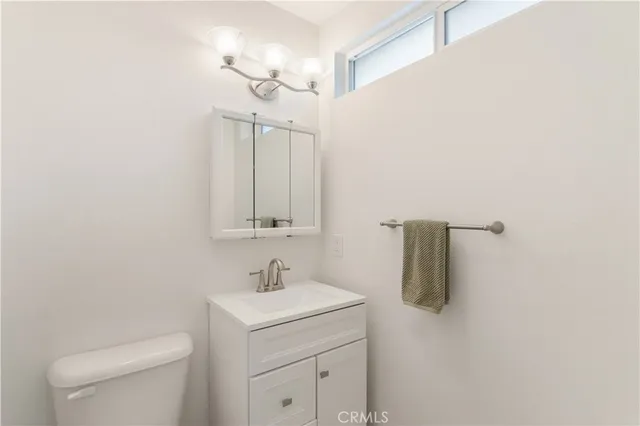 a bathroom with a sink a toilet and mirror