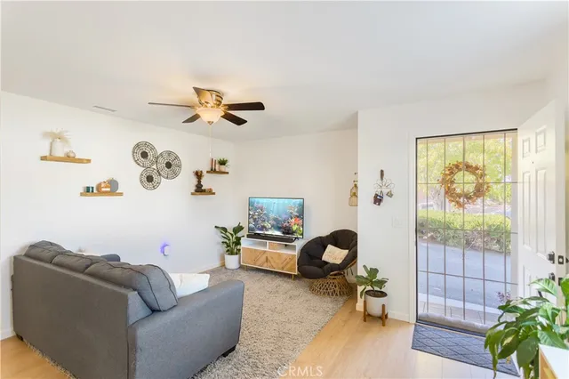 a living room with furniture and a floor to ceiling window