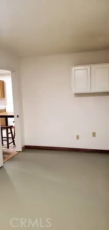 a view of an empty room and wooden floor