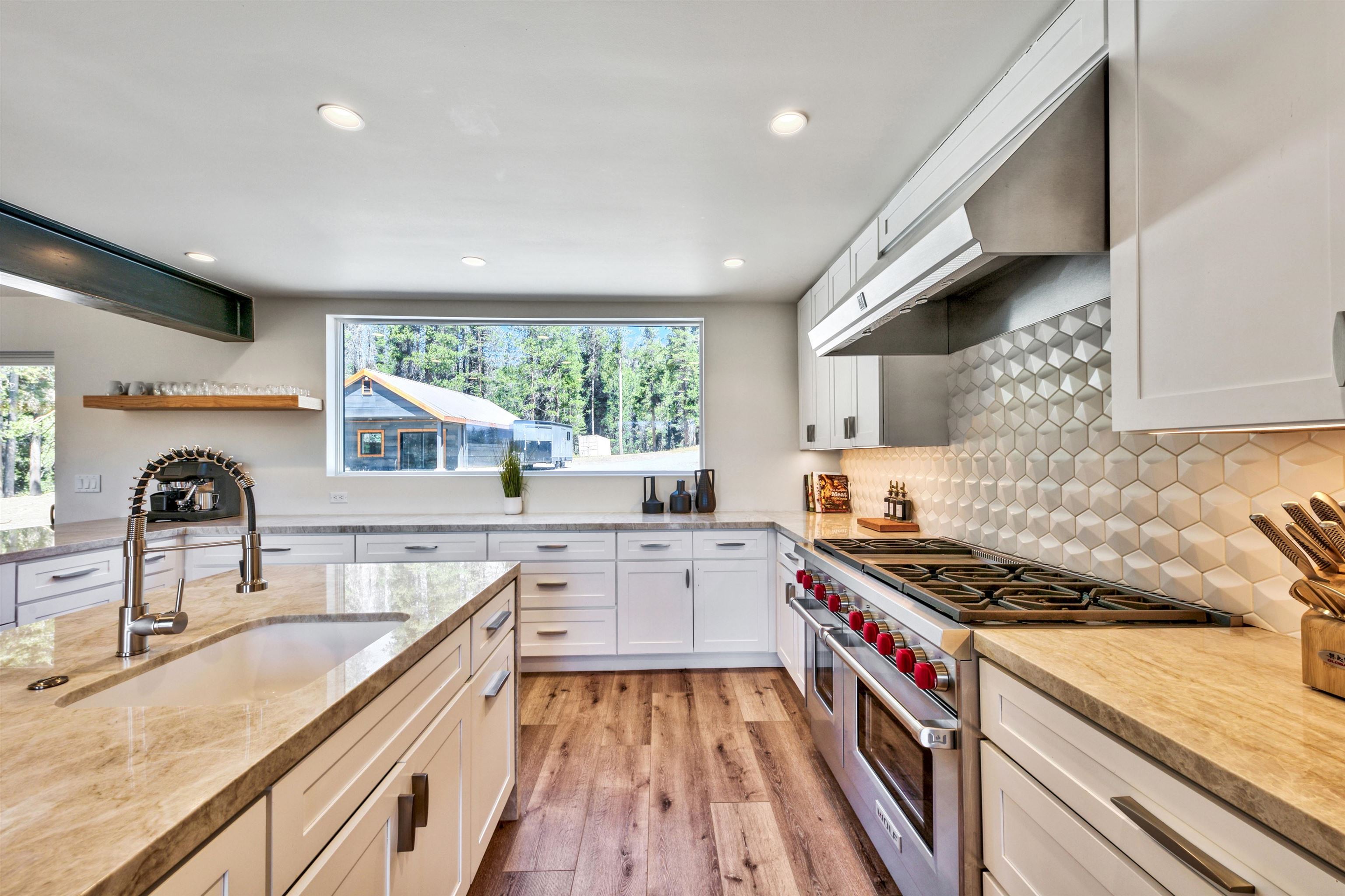 804 Fiberboard Road Sierraville, CA 96126 - Photo 8 of 28 a kitchen with stainless steel appliances granite countertop a sink stove cabinets and wooden floor