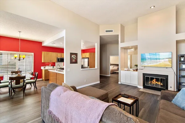 a living room with furniture fireplace and a table