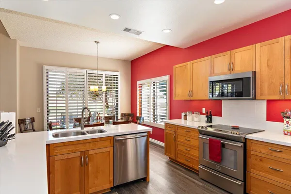 a kitchen with a sink stove and microwave