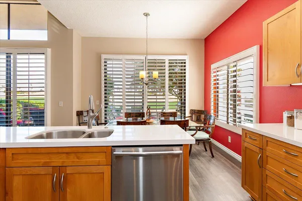 a kitchen with stainless steel appliances a sink and large window