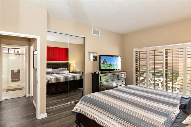 a bedroom with a bed and a television