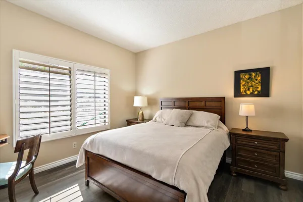 a bedroom with a bed and a table with chair