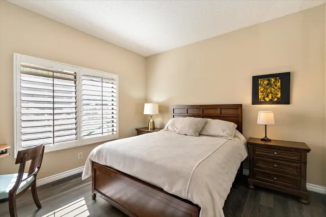 a bedroom with a bed and a table with chair