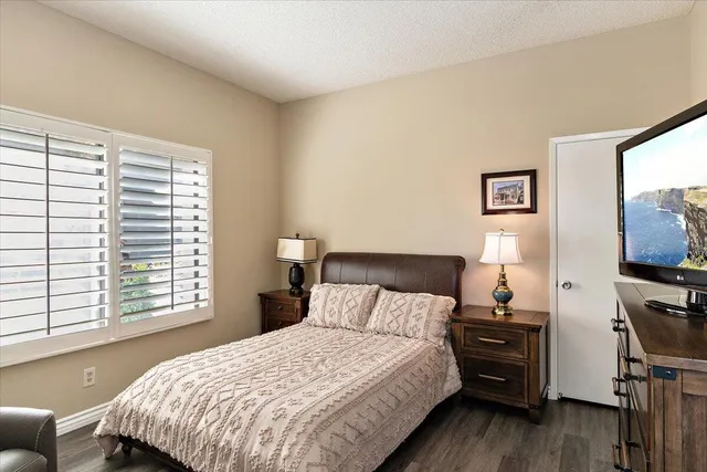 a bedroom with a bed and a flat screen tv