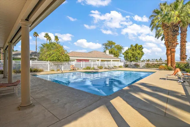 a view of a swimming pool with an outdoor seating